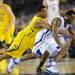 Michigan sophomore Trey Burke Mitch McGary reaches in after the ball as Kansas sophomore Naadir Tharpe dribbles during the first half at Cowboys Stadium in Arlington, Texas on March 29, 2013. Melanie Maxwell I AnnArbor.com
